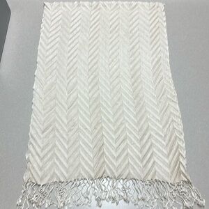 Embossed fringed scarf use as a scarf or put on the back of a chair or couch.
